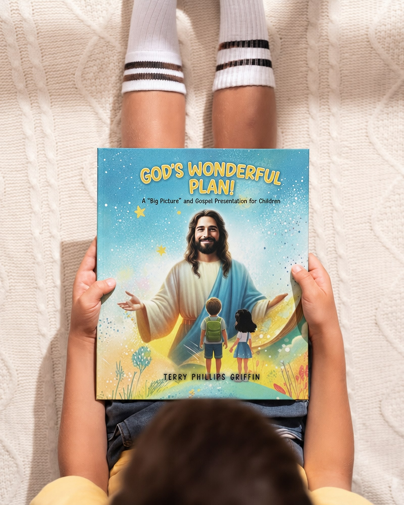 A child holding God's Wonderful Plan! on their lap